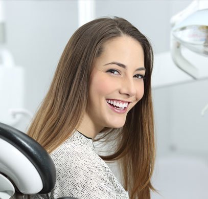 smiling patient seated comfortably in a dental chair